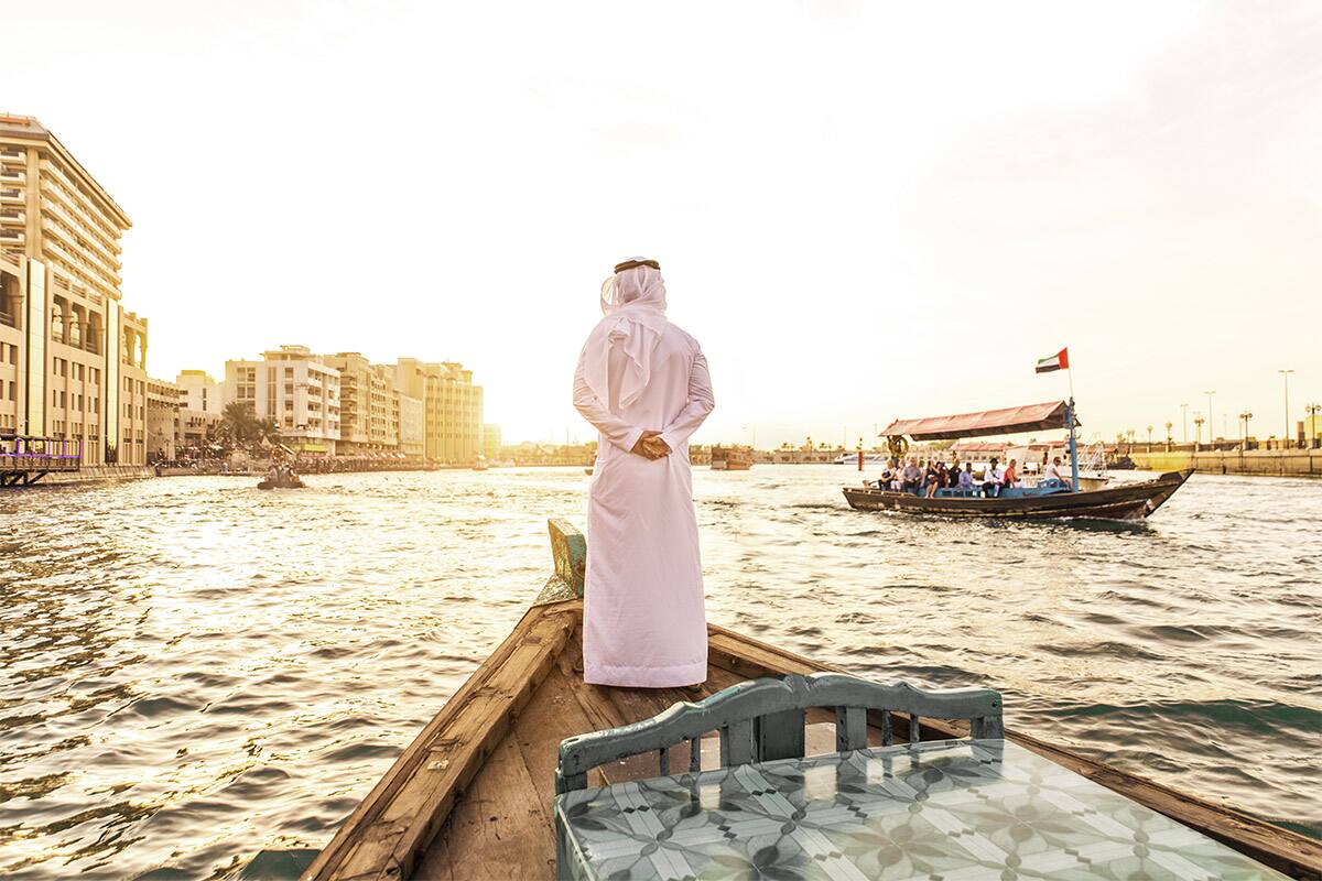 Emirati standing on a boat