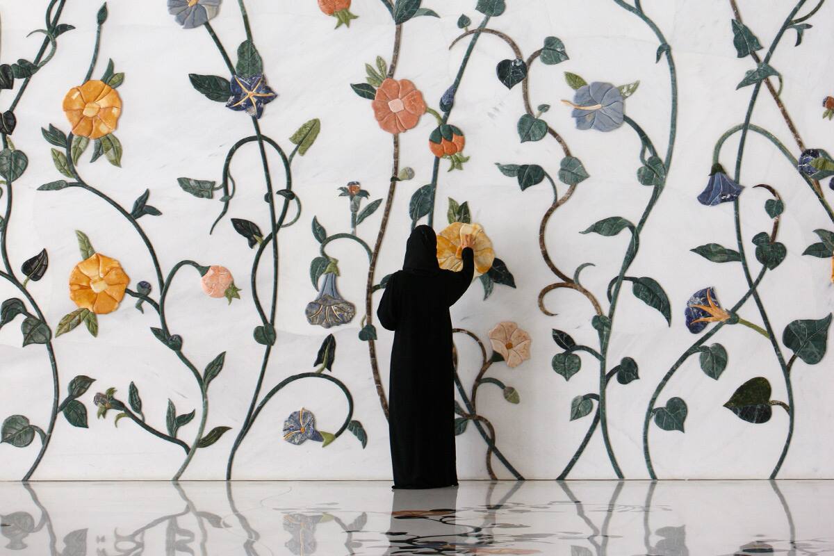 woman drawing flowers on a wall