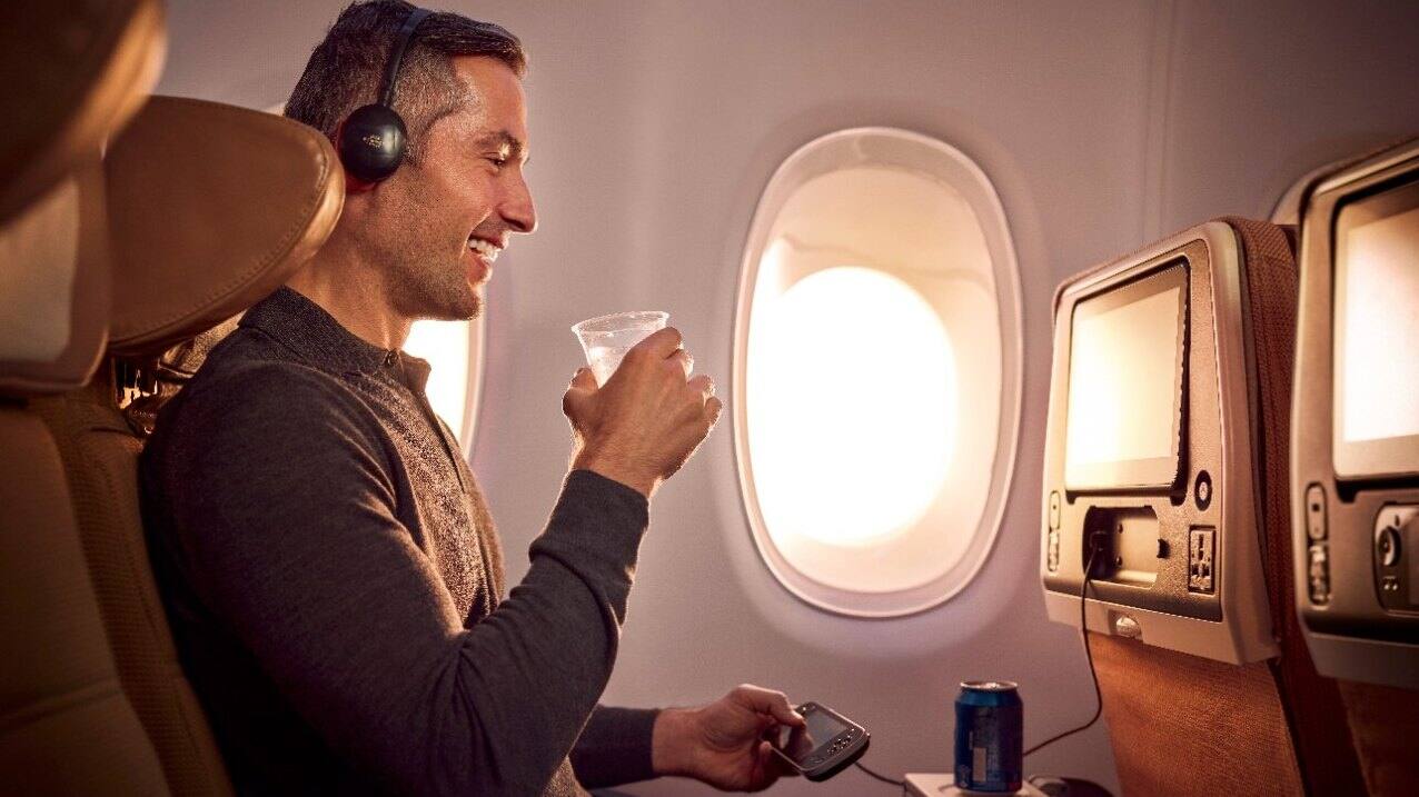 man enjoing meal in etihad economy class